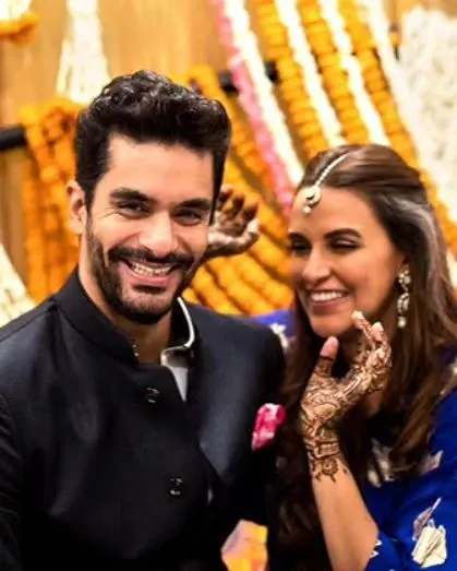 The happy couple, Neha Dhupia and Angad Bedi, showing off the simple, elegant mehandi we designed for their intimate wedding.