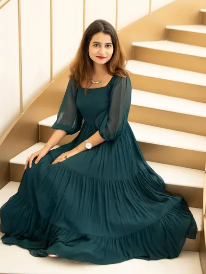 A seated portrait from the same blogger shoot. The soft lighting and the flowing dress create a graceful and sophisticated image.