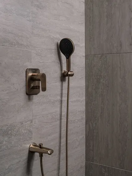 A close-up of the vintage-inspired shower fixtures in the guest bathroom, showcasing our attention to detail and material quality.