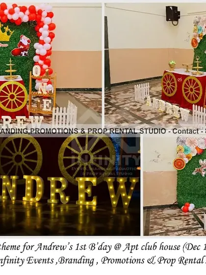 A unique twist on a first birthday theme, combining Royal Prince elements with a festive Christmas vibe. This setup at an apartment clubhouse features a grass wall, a red carriage prop, and Christmas-themed balloon colors for a fun and seasonal celebration.