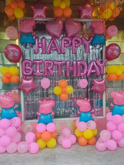 Another angle of the Peppa Pig themed birthday decoration, showing the full arrangement with multiple character balloons.