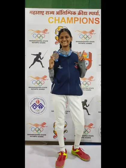A happy medalist showing off her medals at the Maharashtra State Olympic Games. Her joy is a reflection of the positive and encouraging environment we foster at the club.