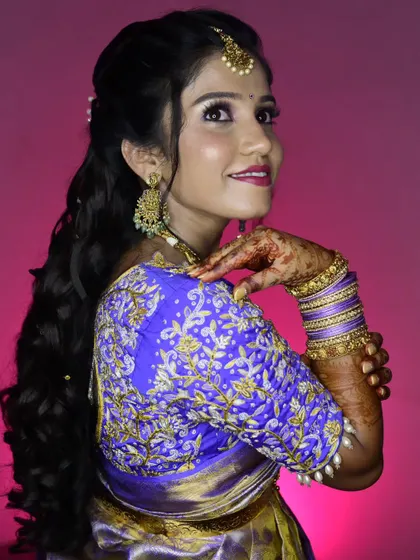 Sahana showing off her stunning embroidered reception blouse. The hairstyle is kept soft and away from the face to highlight the outfit's details.