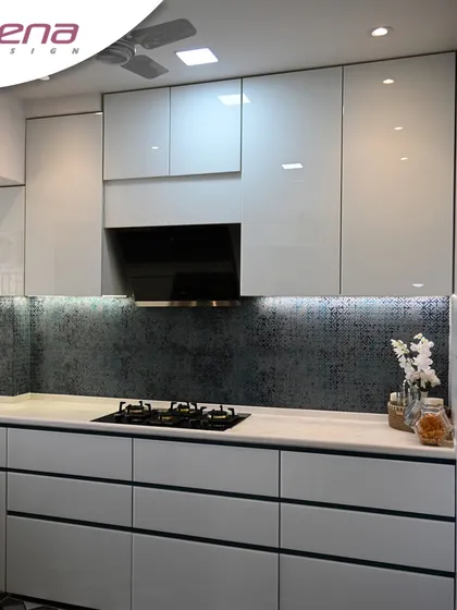 This premium kitchen design uses a textured blue backsplash to add depth and character. The handleless drawers and cabinets are from our factory, ensuring a perfect finish.