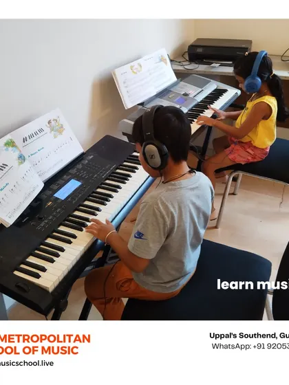 My classroom is set up to facilitate both individual focus and collaborative learning. Here, two students are engaged in a keyboard lesson, learning to read sheet music and play together, which is a key part of my group class experience.
