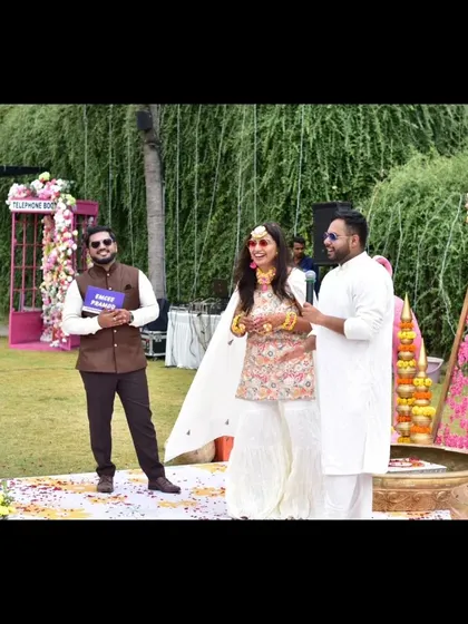 Posing with the couple during a game at their Haldi ceremony. I'm not just a host, I'm a co-creator of their happy experience.