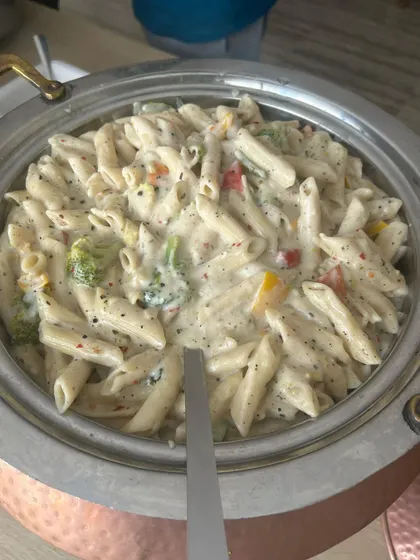Creamy white sauce pasta served hot from the chafing dish. This continental favorite is a staple in my corporate menus, offering a comforting and delicious option for employees and guests.
