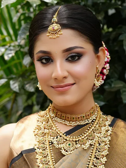 A stunning portrait of a South Indian bride. The makeup highlights her beautiful features, creating a look that is both traditional and glamorous.