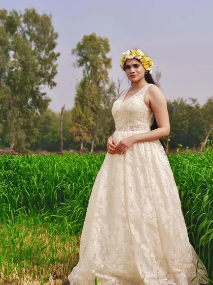 This full-length view showcases the beautiful texture and silhouette of the custom lace gown. It's a versatile piece that can be styled for a bohemian, rustic, or classic pre-wedding photoshoot.