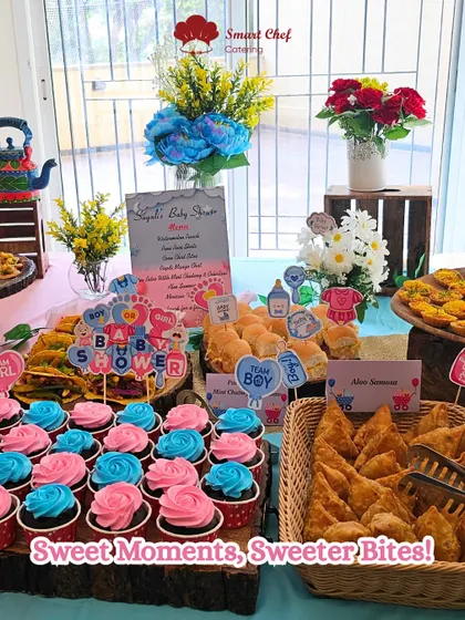 Sweet moments and sweeter bites at a baby shower. This table is adorned with pink and blue cupcakes, themed signs, and a variety of delicious snacks.