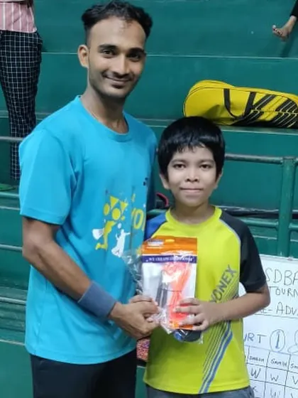 A coach awarding a prize to a young winner at our internal tournament. These events are a great way to introduce junior players to a competitive format.