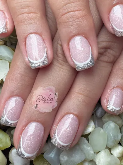 The silver lining. This manicure screams sophistication with its shimmery pink base and sparkling silver French tips.