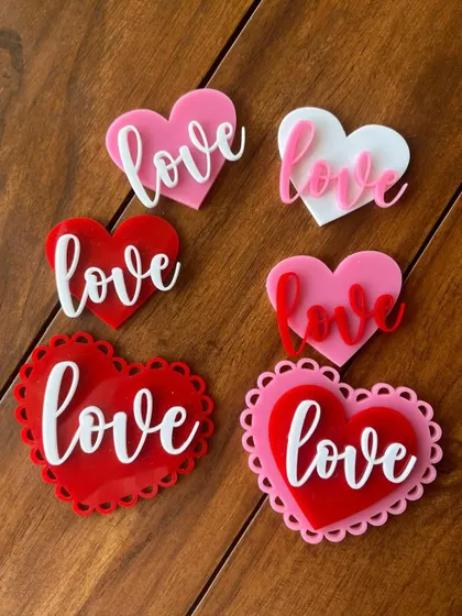 A collection of our "Love" themed acrylic charms, perfect for Valentine's Day, anniversaries, or just because. They come in various styles and colors to match any sweet treat.