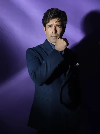A close-up from the purple series, with a pensive pose that adds to the mysterious and cinematic feel of the shot.