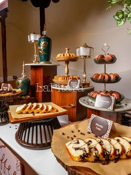 A close-up of the dessert and pastry cart. We use multi-level platters, wooden boards, and elegant urns to display food beautifully, turning the catering into a part of the decor.