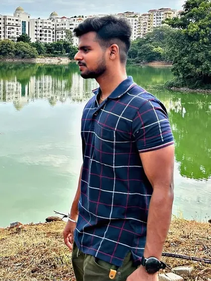 A side profile shot capturing a moment of reflection by the water.