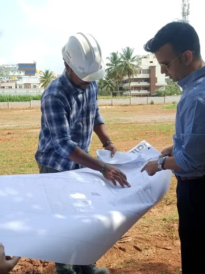 Our principal architect on-site, reviewing blueprints and verifying the set-out for a new project to ensure the execution aligns perfectly with the design vision.