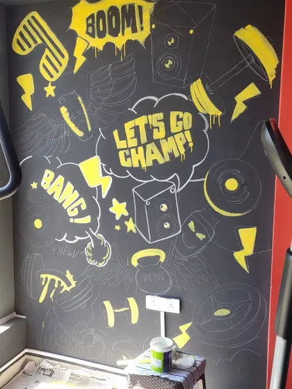 The mural begins to take its final form as I add the bright yellow accents. This selective use of color creates high contrast and makes the key phrases and icons stand out.