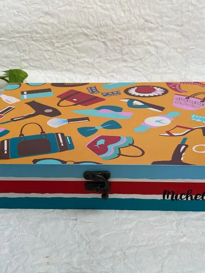 A multipurpose organizer box I created as a farewell gift. The top is decorated with a fun, fashion-themed print and personalized with the recipient's name.