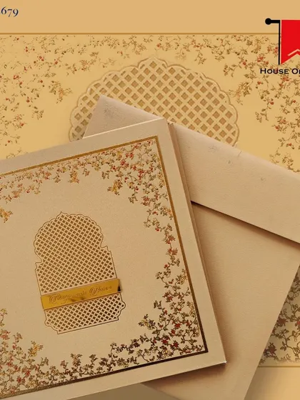 This luxurious invitation features a laser-cut jali pattern on a beige background with gold foil accents. It's a sophisticated and elegant choice.