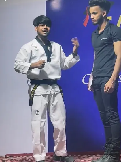 Demonstrating a self-defense technique on stage at an event. I explain the principles behind the move before showing how it is done.