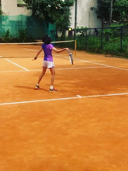 A junior girl hits a backhand during a rally in the Juniors and Men’s Open Tournament.