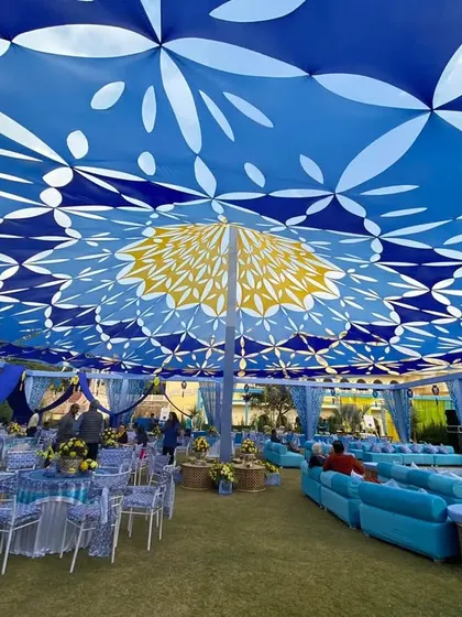 For this Mehendi, I used a "Jaipuri Blue Pottery" theme, with a stunning printed blue and yellow canopy covering the entire outdoor space, creating a royal Rajasthani vibe.