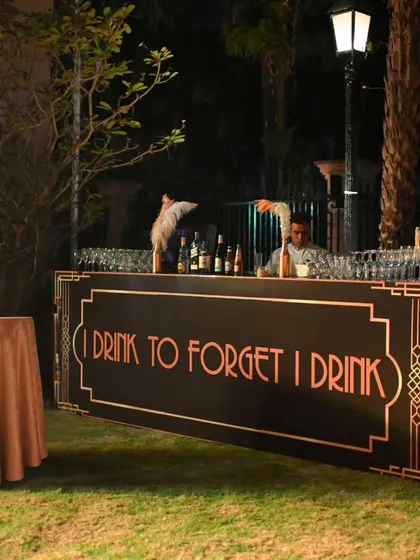 A custom-designed bar for the outdoor area of the party. The witty quote and art deco font added a touch of classic Gatsby charm and humor.
