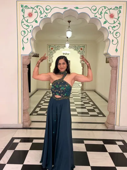 A front double bicep flex, complete with mehendi. You can be strong and feminine at the same time.