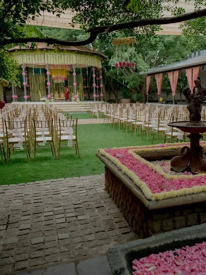 A wide view of the lotus-themed wedding decor, with a fountain and guest seating.