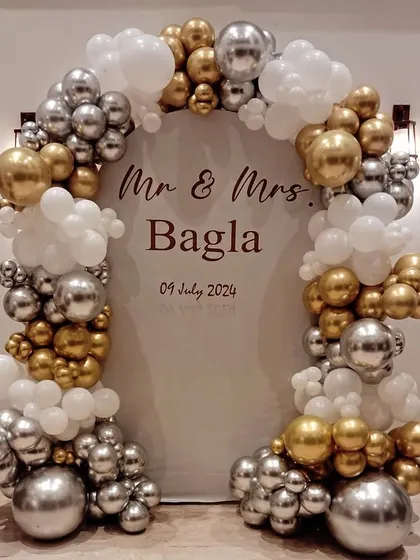 Congratulations to Mr. & Mrs. Bagla on their anniversary. We created this elegant personalized backdrop with a chrome gold and silver balloon arch to help them celebrate their special day in style.