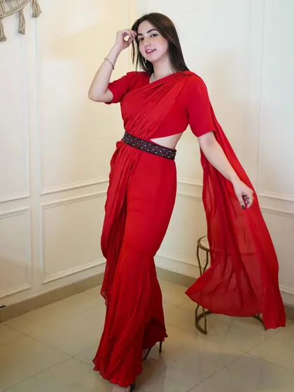 A full-length shot of the red belted saree, showing off its unique silhouette. It's the perfect blend of traditional and contemporary style.