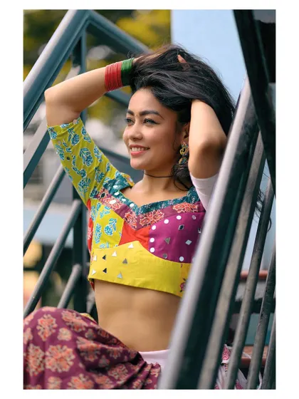 A candid, happy moment captured on a staircase. The natural pose and genuine smile make this portrait feel authentic and full of life.