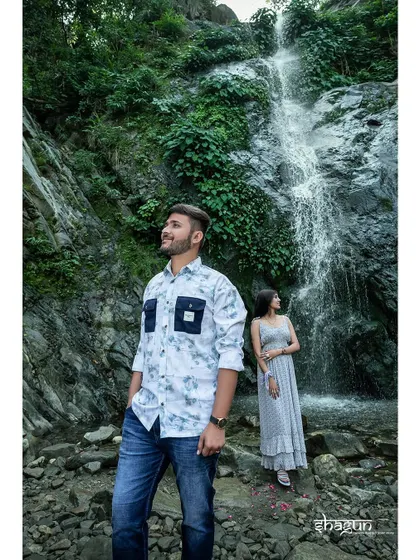Posing against a stunning waterfall, this shot captures the power and beauty of nature. It's a perfect backdrop for a couple with an adventurous spirit.