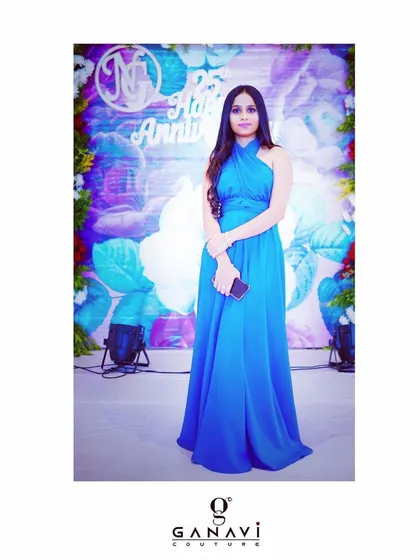 A full-length view of the client in her classic blue drape gown, a signature piece from my collection that is perfect for any formal event.