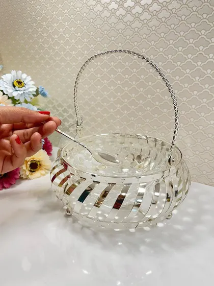 Make your festive gifting special with this silver-plated basket. The swirling open-work design is modern yet elegant, and it comes with a small spoon for serving treats.