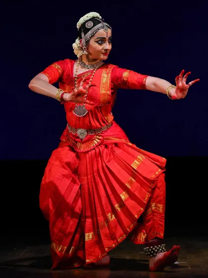 A full-body action shot, capturing the energy and flow of a pure dance sequence. The movement of the costume adds to the dynamism.
