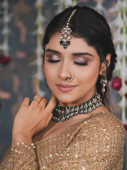 A close-up on the eye makeup. The blending is key to a soft yet defined smokey eye. It adds depth and drama without overwhelming the look, making it perfect for bridal portraits.