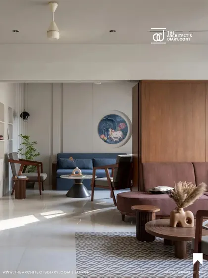 **Oatmeal House, Ahmedabad:** The living room of the Oatmeal House features a calm, neutral palette with pops of color from the furniture and art. The design uses clean lines and uncluttered surfaces to create a sense of tranquility, with custom niches for personal objects.