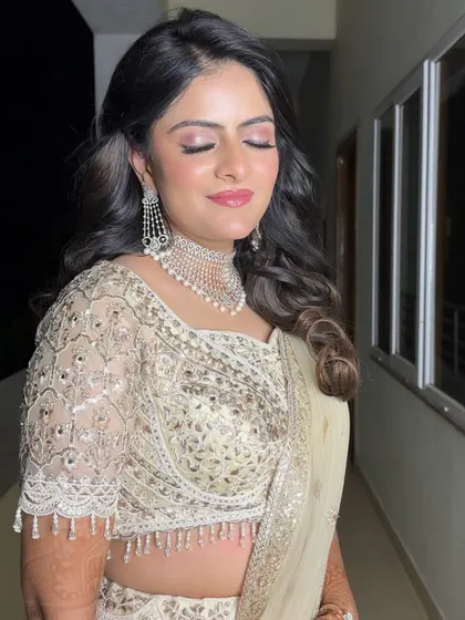 A close-up of Kritika's soft glam makeup. The shimmering pink eyeshadow and flawless skin create a look that is both romantic and sophisticated.