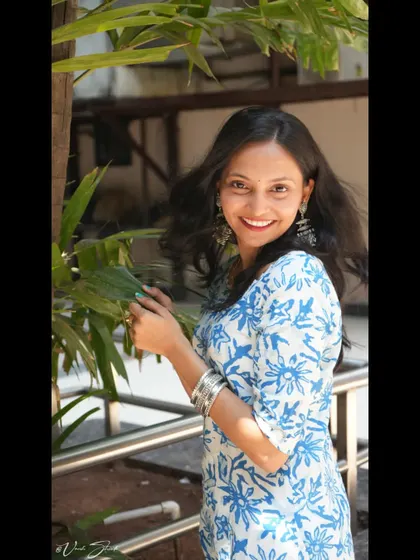 A beautiful, smiling portrait in a lovely traditional kurti. The natural light and greenery in the background make this a fresh and vibrant lifestyle photograph.