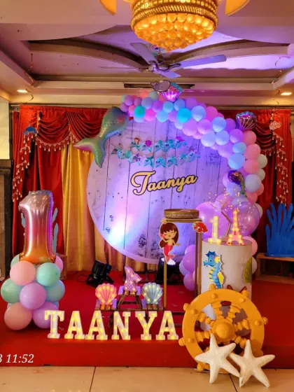 This version of the mermaid theme uses a large number '1' balloon and character cutouts to celebrate a first birthday.
