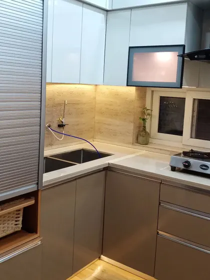 A closer look at the sink area, showing the double sink and under cabinet lighting that illuminates the workspace.