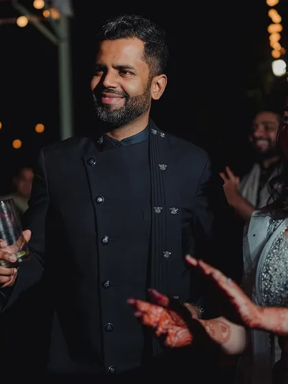A candid shot of the couple enjoying their reception party, surrounded by friends and good vibes.