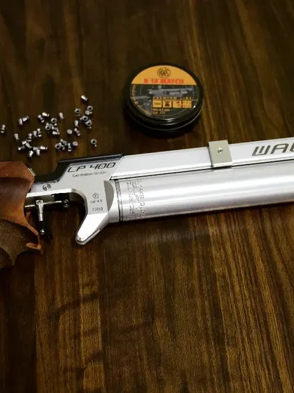 A classic Walther LP400 air pistol with its .177 calibre pellets. This is the kind of precision equipment you'll be using during your session with me.
