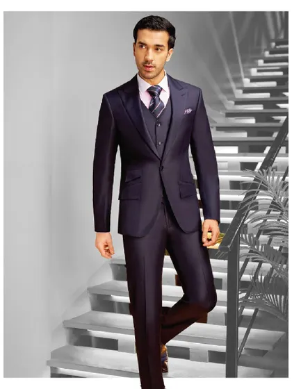 We craft suits that make statements, not just impressions. This deep navy three-piece suit with a subtle sheen is tailored for a powerful and elegant silhouette.