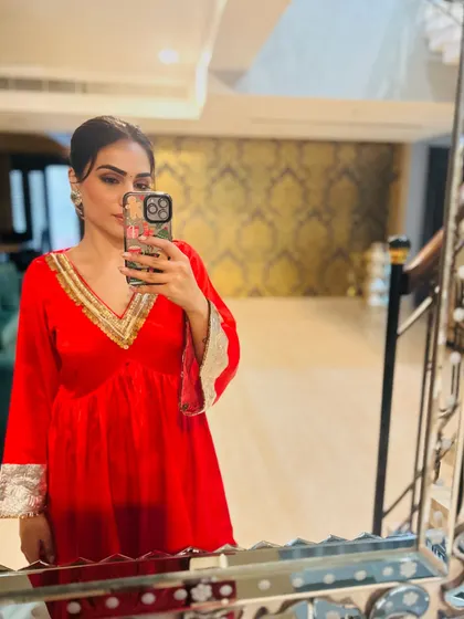 A mirror selfie in a red peplum-style kurta with silver gota patti work. This is a more playful take on festive wear.