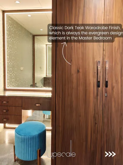 The classic dark teak wardrobe finish is an evergreen design element that brings warmth and timelessness to this master bedroom's dressing area.