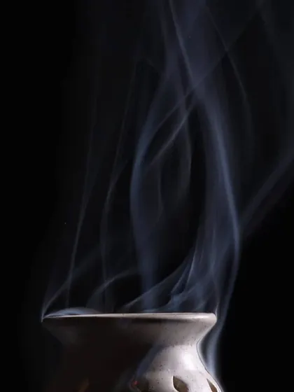 Another take on the rising smoke, capturing a different pattern in its elegant dance. This series explores the beauty of simple, ephemeral moments.