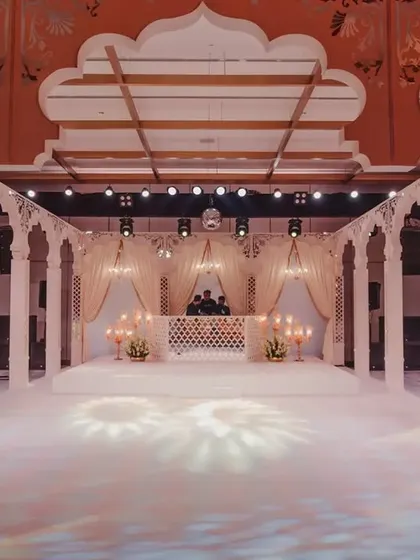 The dance floor and stage area, framed by majestic pillars and arches. I wanted to create a central space that felt both grand and intimate for the couple's celebration.
